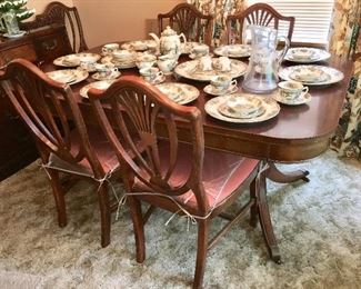 Antique dining room table and chairs and Johnson Brothers Friendly Village dinnerware. There are 13 different plates depicting covered bridges and more.