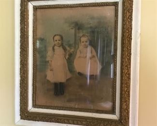 Antique hand-colored portrait of two children in period frame.
