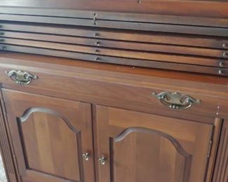 Saginaw Table extendable table six leaves. Cabinet with silver drawer. 