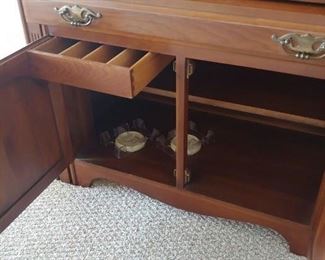Saginaw Table extendable table six leaves. Cabinet with silver drawer. 