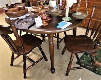 Colonial style table with 4 chairs in great condition.  Lots of carved wood serving pieces