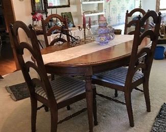 Prized, elegant, yet with simple lines, dining table seats 8. With 2 leaves removed it can become sized an elegant kitchen table, in the office or den, game table,  porch table. 
Beautifully made of oak with high back seats. simple & easy to decorate around or complement any decor.