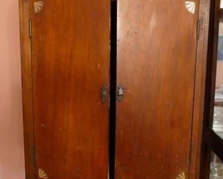 one of a kind 19th century wooden cabinet with shell motif on corners