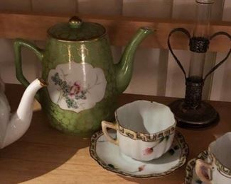 A collection of decorated cups and saucers