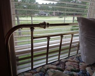 brass headboard on queen bed