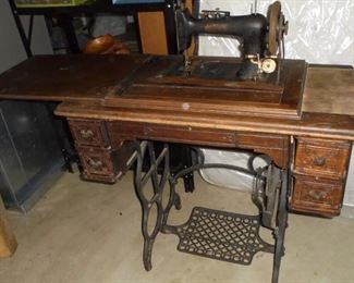 Antique Singer sewing machine in cabinet