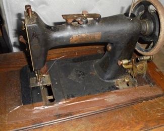 Antique Singer sewing machine in cabinet