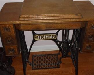 Exquisite antique singer sewing machine in Tiger oak cabinet