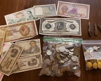 World currency and coins, vintage coast guard officer uniform buttons, arrowheads and coast guard pins.