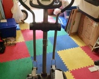 Pro-Form Elliptical.  Works well.  Rubber floor tiles are for sale too!