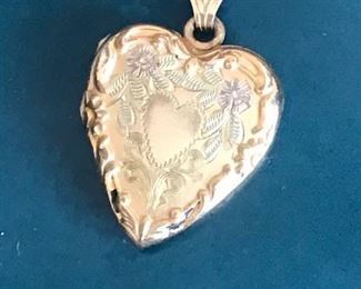 14 kt gold chain with heart charm.