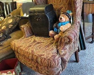 Teddy sits on a great arm chair