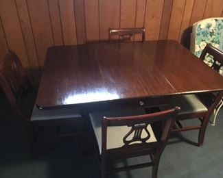 Drop Leaf Table - Located in the Basement/Patio
•	Clawfoot
•	4 Chairs
•	Harp Style Chair Back
•	Dark Wood
•	Table Extends to 48"x36"
•	When Dropped - 16" Center