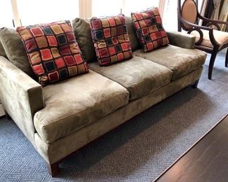 Green microsuede sofa with pillows