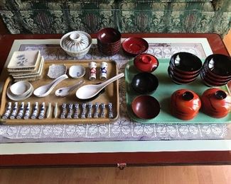 Collection of Japanese rice bowls and soup bowls, chopstick rests and rests.
