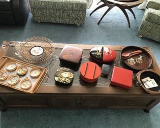 Custom made Japanese coffee table with carvings and glass tabletop. An assortment of vintage Japanese serving pieces.