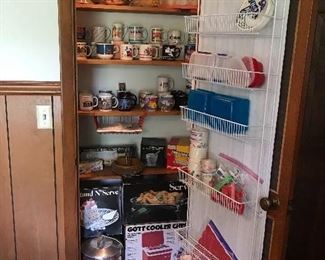 Large collection of souvenir coffee cups. Gott cooler, Regal picnic carrier, along with cooking aplliancesAll of these are new. Vintage metal cooking pieces. Spice racks.