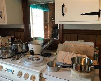 Electric rice cooker, stovetop covers, pots. Cutting boards, spoon rests.