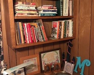 John F. Kennedy photo and 2 brass plates featuring his profile, whimsical vintage child’s desk lamp, wooden bookends with horse heads, decorative wall anchor, “M” wall decor, embroidered pieces, an assortment of books on Bonsai, Italian and German recipes and LIFE books.