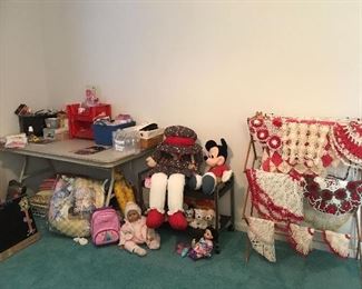 Crocheted dollies and colorful floral bedding for crib in beautiful condition. Webkinz dogs and large doll - in like new condition. Large Mickey Mouse doll, baby Mulan doll with CD and accessories- like new, mini rolling Disney princess case - like new, miscellaneous dolls and accessories. Holiday decor, crafts and party supplies- most are new, along with assorted cards and invitations.
