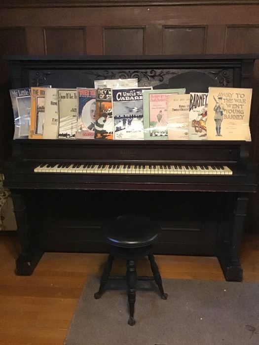 Upright piano and stool from about 1914 with some sheet music from the same era. 