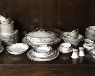 12 place settings of Noritake chinaware withmany serving pieces from around 1920.  Some pieces are in their original wrapping. 