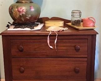 Small dresser, lamp, and other items.