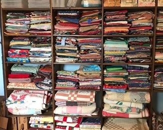 Boxes, fabric, finished quilts, quilt projects in progress 