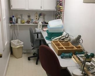 Sewing work room with sewing machine and misc sewing supplies