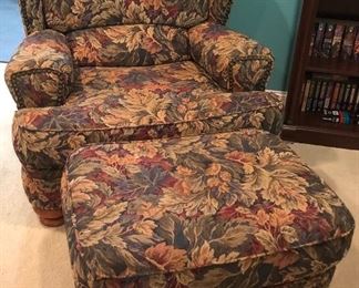 Comfortable upholstered easy chair with ottoman.  