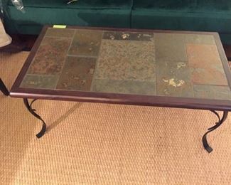 One of several slate top wood and iron tables