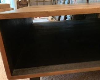 #27	wood teck 4x4 custom made coffee table with storage under it on metal legs 	 $350.00 
Storage hole
