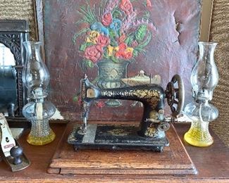 Vintage Singer sewing machine with cabinet. Pair of oil Hurricane lamps