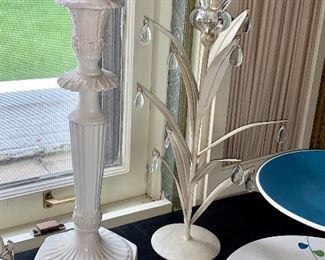 Two sets of white candlesticks each with a matching pair