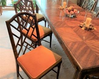 AVAILABLE FOR PRESALE: An Asian motif extension dining table and six chairs from the Chinese Chippendale series made by Century Furniture. The set features a faux bamboo motif. There are two dining arm chairs and six side chairs, all with a Chinese Chippendale-style fretwork. The table’s top surface has a patterned veneer, and two additional 18" leaves. The chair seats are upholstered in a burnt orange velvet fabric. on one leaf is lighter than other table surfaces. Optional china cabinet, sideboard, and mirror also available. 

Dimensions
43.0" W x 29.5" H x 83.0" D
- table dimensions noted with one leaf inserted; each leaf adds 18" to table size; chairs are 19″ × 39″; seat height 17".