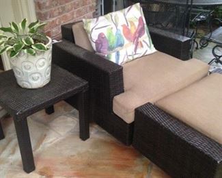 One of two patio chairs and ottomans