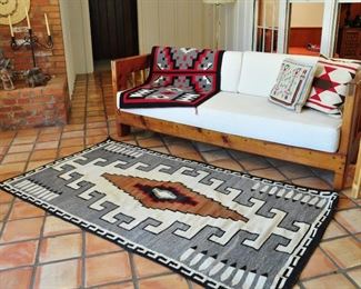 Taos Daybed Sofa with lovely white upholstery fabric shown with 2 of the Native American rugs