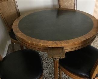 Heritage Game Table with Black Leather table top, 4 pullout coasters and 4 Cane-back chairs and seats with Black Leather cushions.