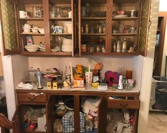 Cupboards filled with glass and stoneware and collectibles