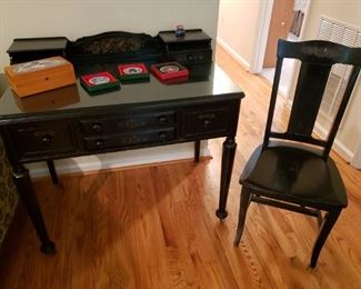 Black desk and chair with gold decor