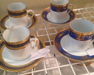 Blue, gold, and white teacups and saucers