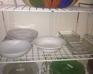 Assorted bowls and plates including green glass scalloped-edge dessert plates