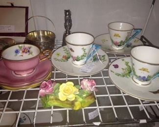 Variety of cups and saucers; more ceramic roses