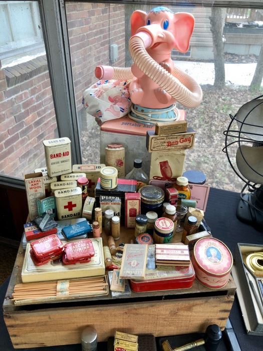 Pink elephant hair dryer, vintage medicine cabinet and ladies' vanity items.