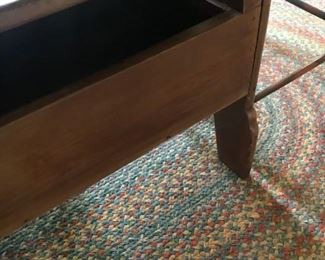 Storage compartment below antique hutch/cabinet table.