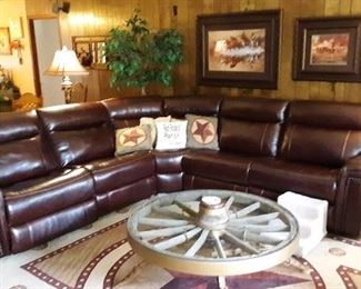 6pc (5 Shown) Leather Sectional with 2 electric and 1 manual recliners and electronic ports. Wagon Wheel table is not for sale.  Western Rug, Pictures, 6' Tree, Floor Lamp are priced to sell.