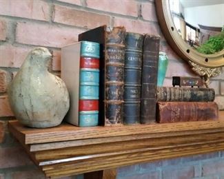 Some of the antique books for sale.  Next to the bird figure is an antique ceramic 'book' flask.