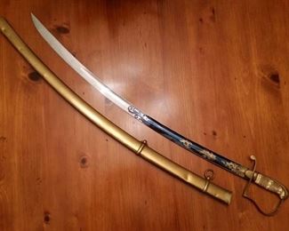 Mid 1800s artillery officer's saber and scabbard.  The blade is embellished with gold gilded designs on niter blue.  Signed "P. Knecht" on one side and "Solingen" on the other near the guard.  