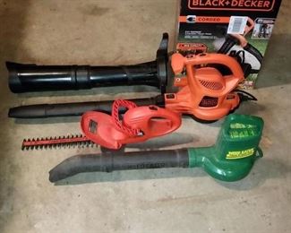 Black & Decker electric leaf blower/vac, Black & Decker electric hedge trimmer, and Weed Eater leaf blower 