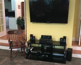 Samsung Flat Panel TV & Entertainment center with some audio equipment, occasional chair